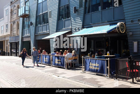 People eating outside at Jamie Oliver Italian restaurant in The Lanes Brighton UK Photograph taken by Simon Dack Stock Photo
