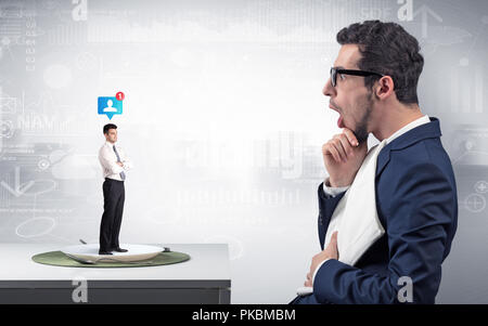 Giant businessman eating small man with financial background  Stock Photo