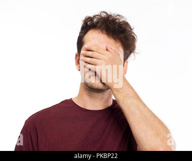 Young man blocking face with hands Stock Photo