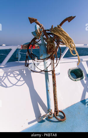 Rusty Anchors on Dive Boat Deck in the Sun with Sea in the Background Stock Photo