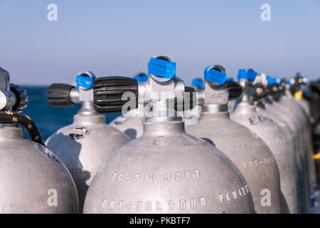Scuba Diving Tanks with Blue Tape and Sea in the Background Stock Photo