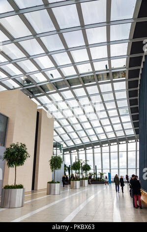 A large walkway with trees and a massive glass roof in the Sky Garden, Walkie Talkie building (20 Fenchurch Street), London, England, UK Stock Photo