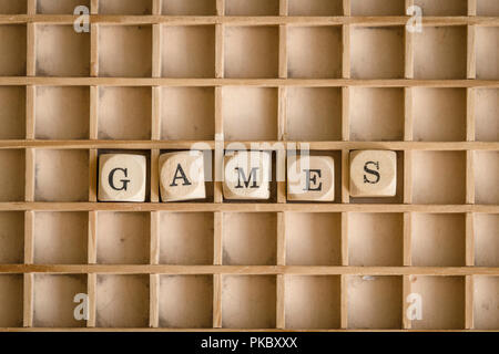 Games word written with dices on a wooden board Stock Photo