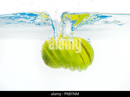 Fresh lime falling into the water. Suitable for advertisement. Stock Photo