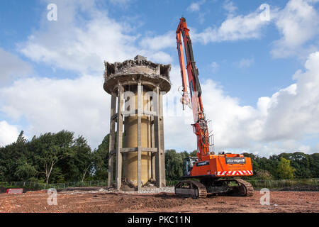 Southport, Lancashire, UK. 12th Sep, 2018. Demolition of Greaves Hall Water Tower, with jaw crusher to demolish building superstructures. This brownfield site is being cleared for the construction of 128 residential houses. The Seddon Homes development will be next to recent residential developments and a continuation of the expanding house building industry in the north-west. The reinforced cement concrete water tower supplied the hospital with an abundance of water for the care centre which has long since closed. Credit: MediaWorldImages/Alamy Live News Stock Photo