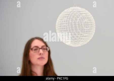 London, UK.  12 September 2018.  A staff member views the design of a sphere incorporated into the Academy Museum of Motion Pictures in Los Angeles, USA, at a preview of 'Renzo Piano: The Art of Making Buildings', an exhibition of works by the internationally renowned architect and Honorary Royal Academician Renzo Piano.  An overview of 16 of his most significant projects are on display in an exhibition which runs 15 September to 20 January 2019 at the Royal Academy of Arts in Piccadilly.  Credit: Stephen Chung / Alamy Live News Stock Photo