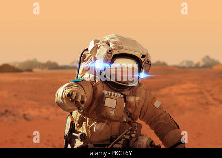 Spaceman walks on the red planet Mars. Space Mission. Astronaut travel in space Stock Photo