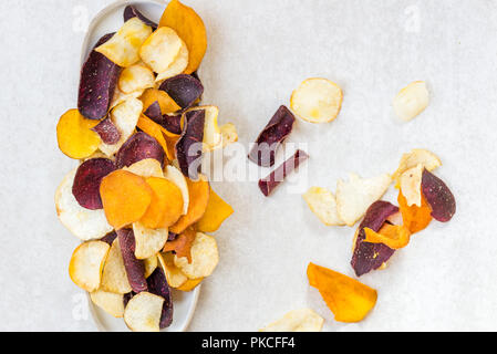 Bowl of Healthy Snack from Vegetable Chips, such as Sweet Potato, Beetroot, Carrot, Parsnip on Light Grey Background Stock Photo