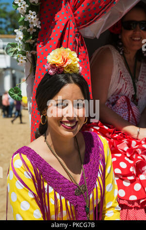 Woman wearing a colourful gypsy dress, Pentecost pilgrimage of El Rocio, Huelva province, Andalusia, Spain Stock Photo