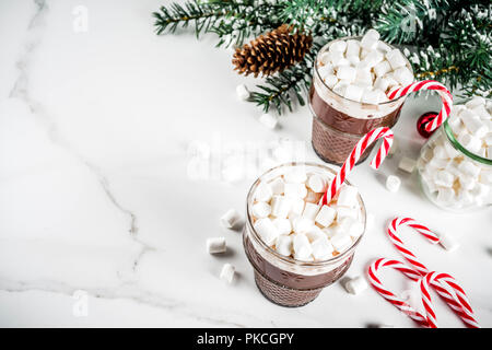 Christmas candy canes in cup on white background Stock Photo - Alamy