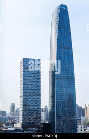 Perspective and underside angle view to textured background of modern glass building skyscrapers over blue cloudy sky Stock Photo