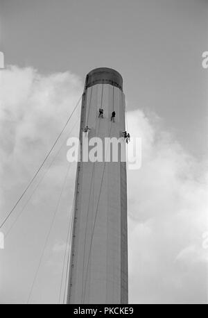 Workers painting an industrial chimney, Hackney, London, 1965. Artist: Laurence Goldman. Stock Photo