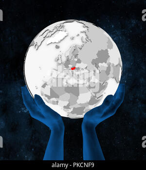 Hungary In red on white globe held in hands in space. 3D illustration. Stock Photo