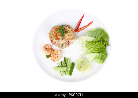 Isolated of  Fried rice with shrimp,fresh prawn, topped sliced red hot chili pepper ,sliced cucumber ,halved green lemon and garlic on white plate Stock Photo