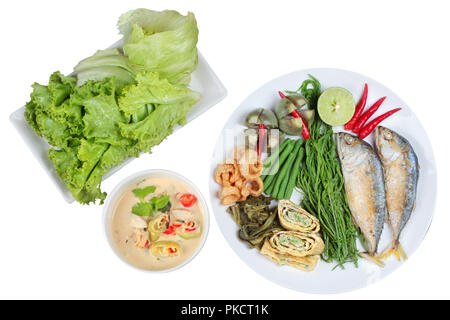 Coconut milk and fermented soy bean sauce call Toa Jiaw Loan in Thai and dish of deep fired mackarels,vegetable omelet,crispy pork rind,pickle lettuce Stock Photo