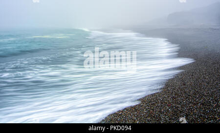 Large copyspace with long exposure of sea linke waves breaking on a foggy day in Northern California, USA Stock Photo