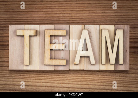 team - text on wooden cubes close-up, top view. Stock Photo