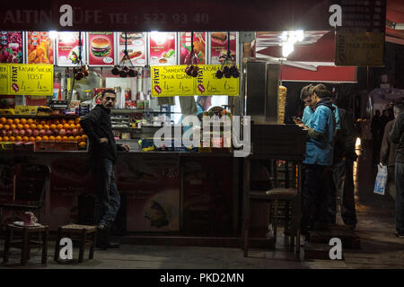 ISTANBUL, TURKEY - DECEMBER 29, 2015: People standing in front of a Bufe, a Turkish street food stand, in the center of Istanbul, selling sanwiches, d Stock Photo