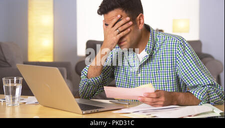 Mexican man holding hand to his face Stock Photo