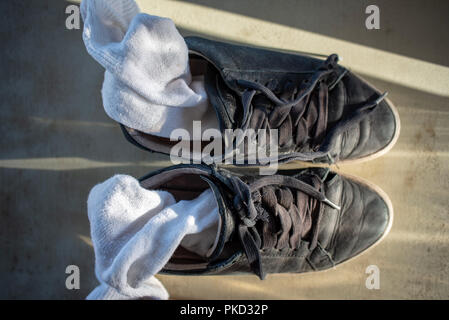 old womens tennis shoes and white socks after workout Stock Photo