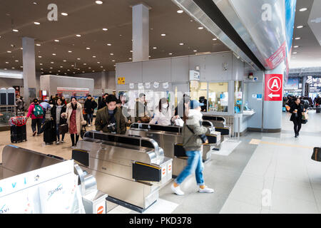 Osaka. Kansai International Airport. Kansia airport station interior. People coming through ticket barriers from JR platform to station concourse. Stock Photo