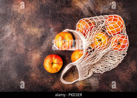 Fresh apples in a mesh bag, top view. Stock Photo
