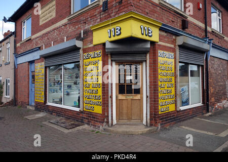 Shop front on a corner is an English Computer repair shop Stock Photo