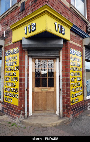 Shop front on a corner is an English Computer repair shop Stock Photo