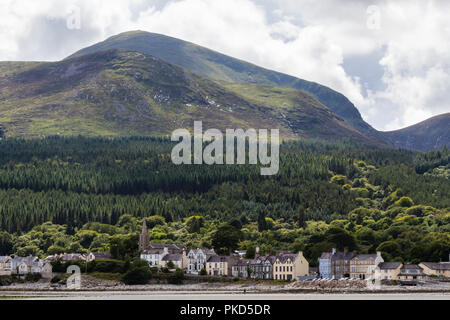Slieve Donard, Northern Ireland's highest mountain, towers over the seaside resort of Newcastle, County Down. Stock Photo