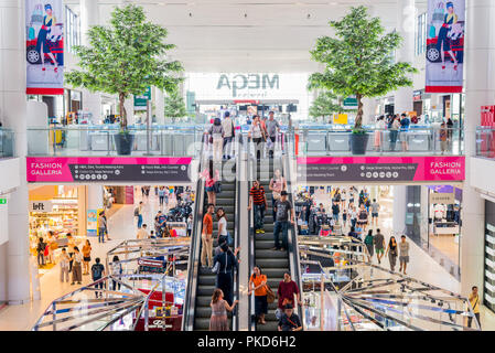 Bangkok, Thailand - July 27, 2018: an interior with two plastic trees and an escalator in Mega Bangna Shopping Mall. Stock Photo