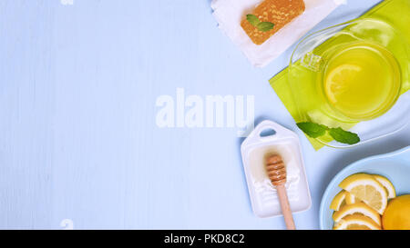 16.9 image of lemon and honey showing a hot drink made for health reasons honey-cone and lemon-slice  shot for copy space with a blue background room  Stock Photo