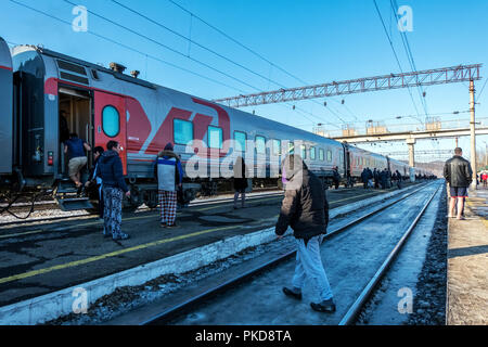 SIBERIA, RUSSIA - MARCH 20, 2018: Trans Siberian Express passengers get out of the station in 15 minutes and relax near Vladivostok, Russia. Stock Photo