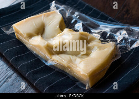 Turkish Traditional Gravyer / Gruyere Cheese in Package From Kars on Wooden Surface. Organic Food. Stock Photo