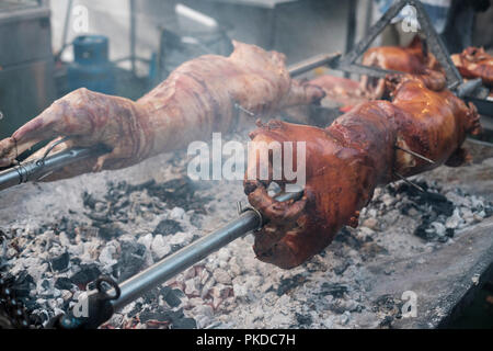 Whole pork and lamb roatsing on spit Stock Photo