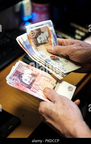 Counting  cash-Pound sterling Banknotes Stock Photo