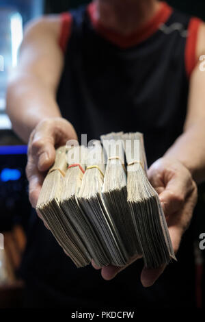 Person holding a stash of money.Corruption concept- cash,dirty money,money laundry Stock Photo