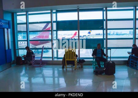 Frankfurt, Germany - April 28, 2018: passengers sitting and waiting for departure inside of Frankfurt Pearson Airport at Frankfurt, Germany on April 28, 2018 Stock Photo