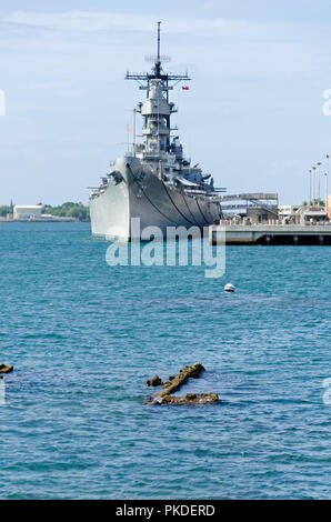 The WWII US navy ship USS Missouri anchored in Pearl Harbor, Hawaii. Part of the sunken USS Missouri is visible in foreground.  Taken in 2010. Stock Photo