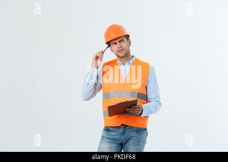 Portrait of Serious architect or engineer writing or taking notes on a clipboard isolated on white background Stock Photo
