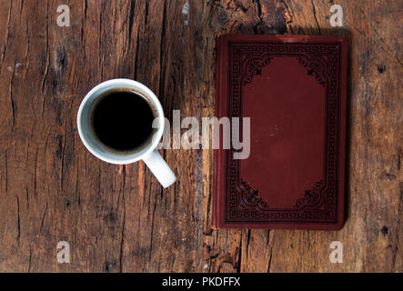 Coffee cup and old book on the wooden table Stock Photo