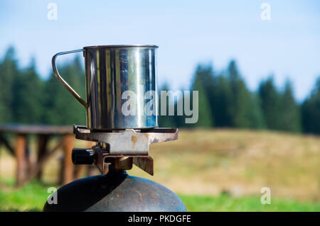 Boiling steaming water in the mountain for tea and coffee Stock Photo
