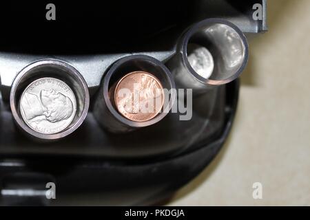 Coins in a coin sorter Stock Photo
