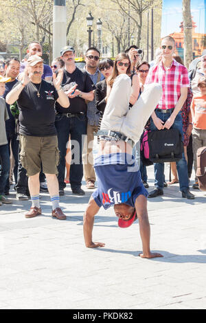 PARIS, FRANCE -  APRIL 25:B-boy doing some breakdance moves in front a street crowd, at Arch of Triumph on april 25, 2013 in Paris. Its popular form o Stock Photo