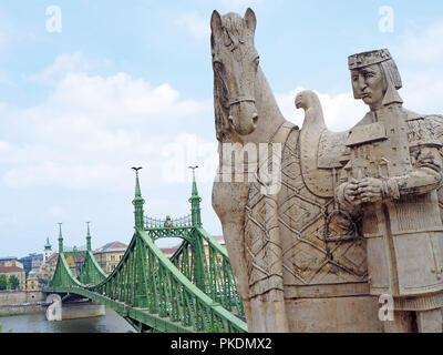 the statue of st stephen with the liberty bridge in budapest Stock Photo