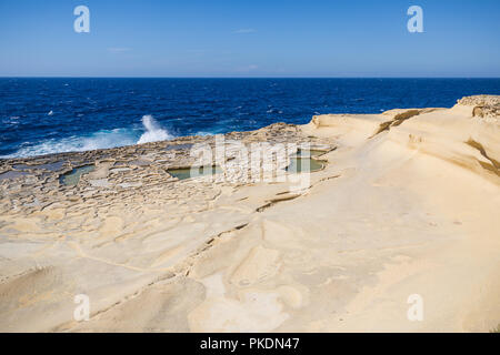 Waves Crashing on Gozo Natural Salines with Mediterranean Sea in the Background Stock Photo