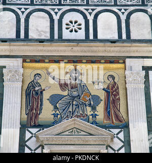 Italy. Florence. Basilica of San Miniato al Monte. Romanesque style. 11th century. Mosaic on the facade. Christ, the Virgin Mary and St. John. Tuscany. Stock Photo