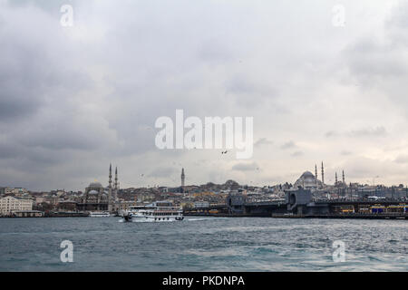 ISTANBUL, TURKEY - DECEMBER 29, 2015: Eminonu and Suleymaniye mosque seen from Galata Bridge (Galata Koprusu), on the European side, with ferry boats  Stock Photo