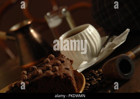 A cup of coffee and a piece of chocolate cake at a cafe in iran Stock Photo