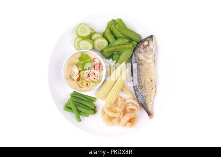 Coconut milk and fermented soy bean sauce with deep fired mackarels,vegetable,crispy pork rind,wing bean,lentils,cucumber and boiled corn. Stock Photo