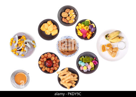 Isolated of  a cup of coffee with colorful Thai local dessert as fried dough stick,neal ginkgo, potato balls,sweet tamarind,steamed layer cake,boiled  Stock Photo